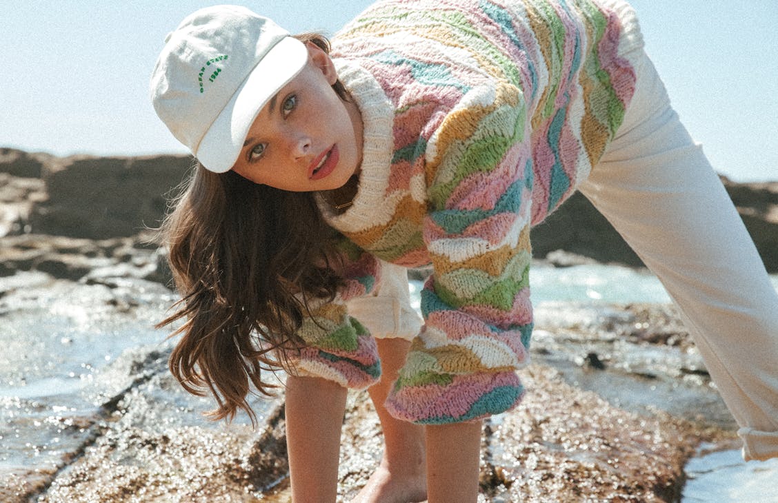 Female model wearing the scallop knit in scallop stripe