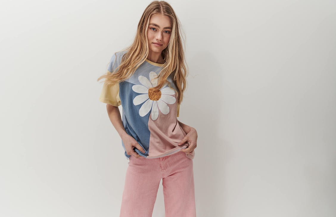 Female model wearing the Panel Thrift Tee in blue, pink and yellow