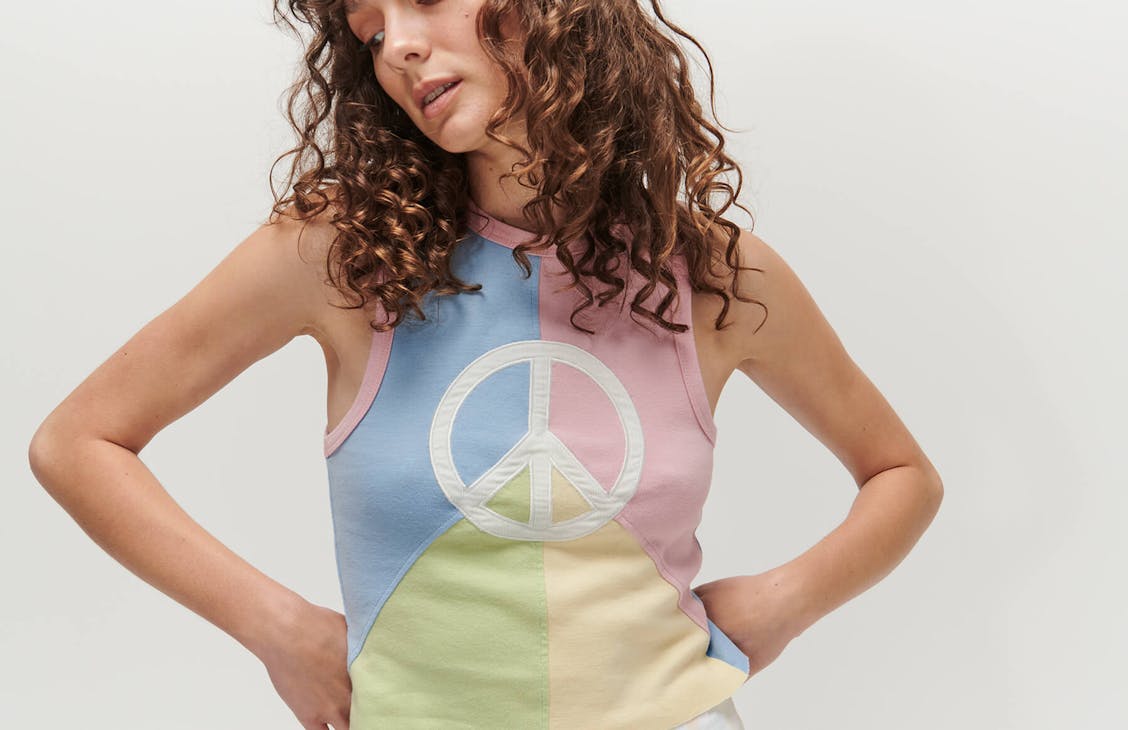 Female model wearing the Peace singlet in multi