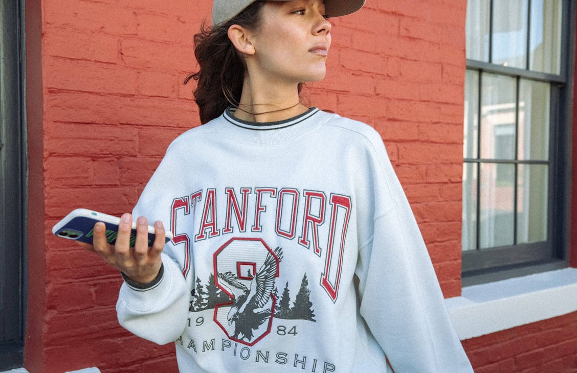 Female model wearing the north crew in cream. 