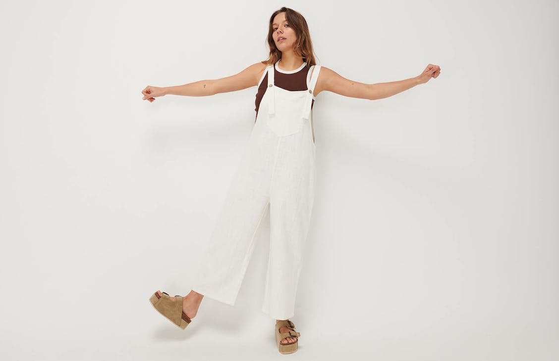 Female model wearing the loose overalls in white.