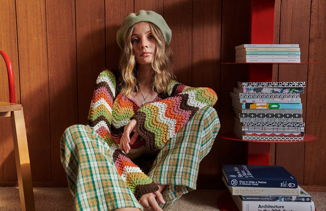 Female model wearing the Illusion Crochet top in illusion stripe.