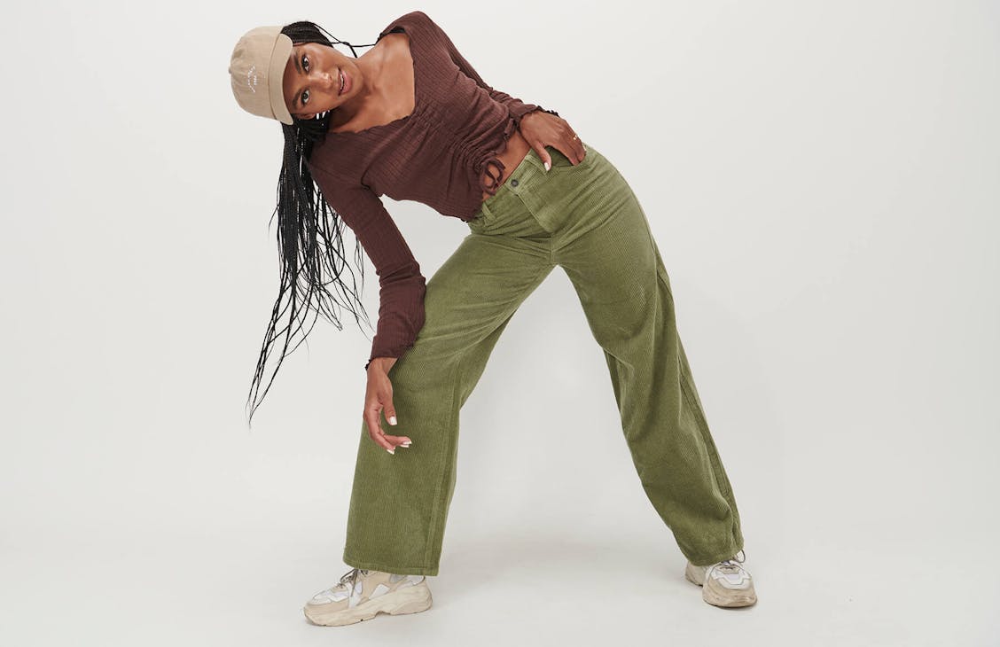 Female model wearing the wide cord pants in matcha. 