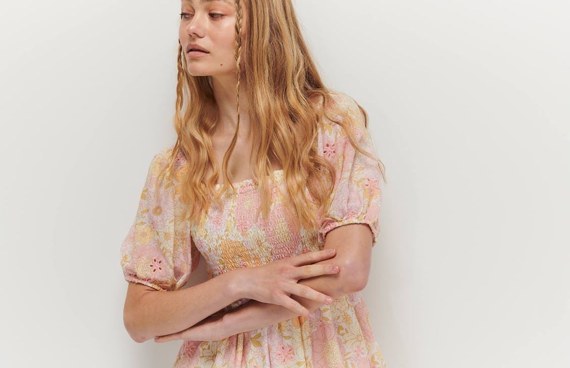 Female model wearing the Bonnie dress in April Floral Broderie.