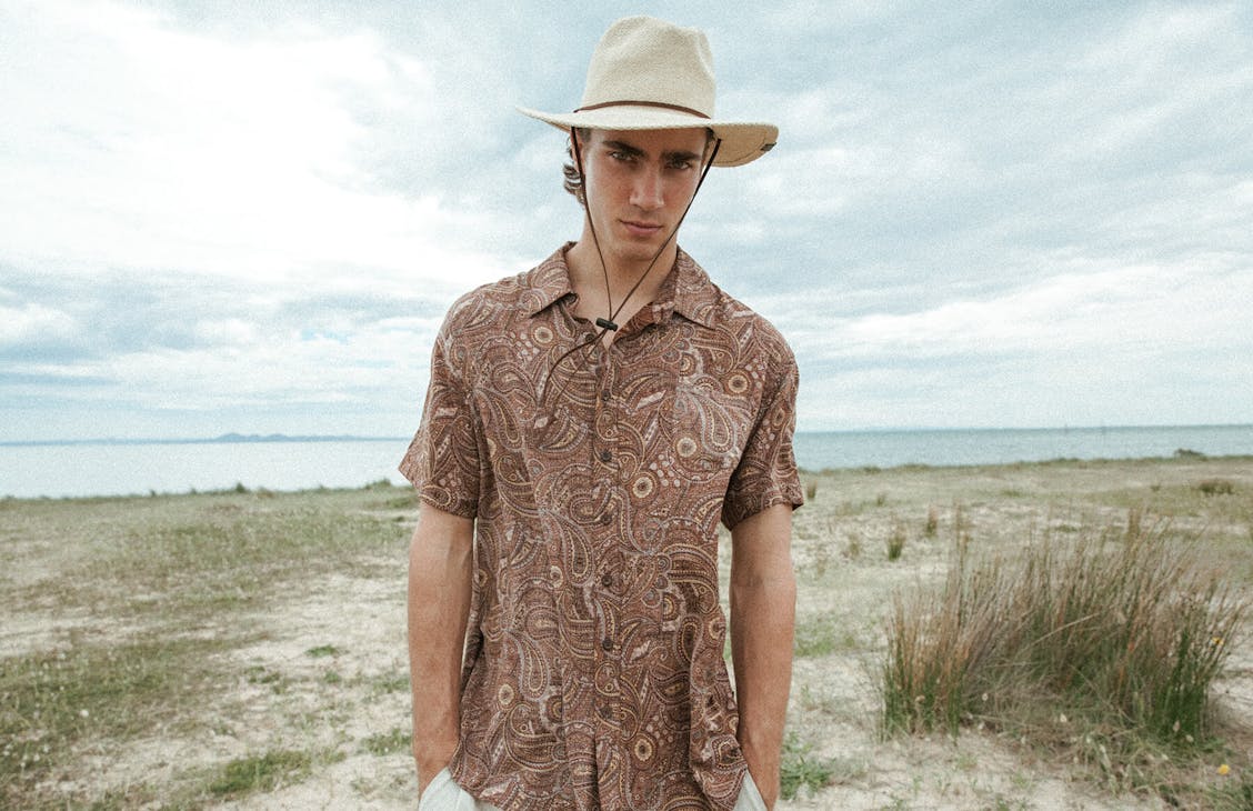 Male model wears the range shirt in natural.