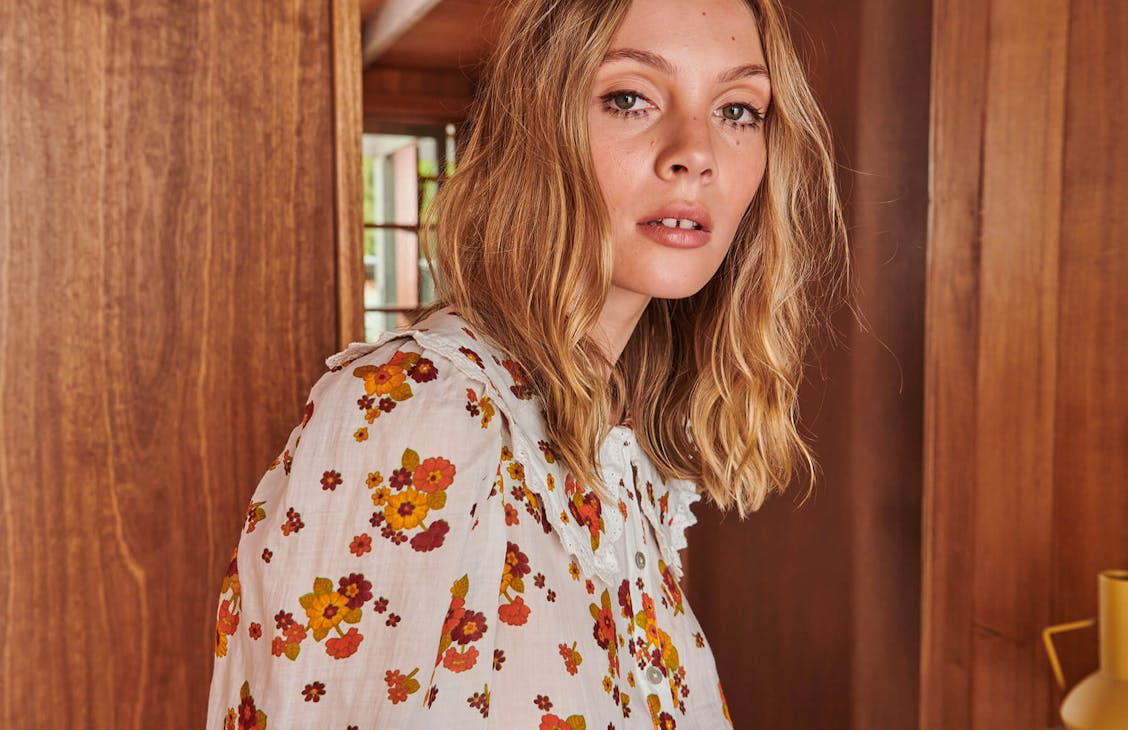 Female model wearing the Meg Shirt in Meg Floral.