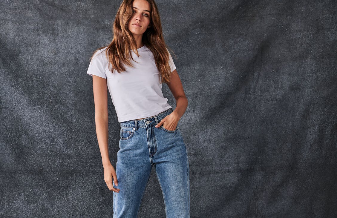 Female model wearing the Kendall jeans in Kendall Blue. 