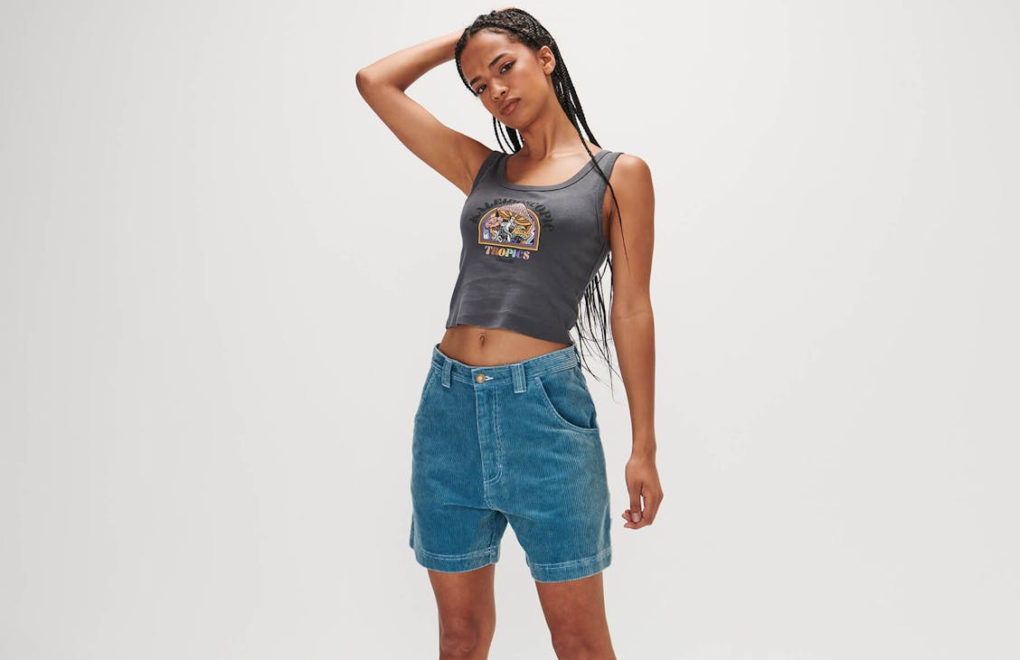 Female model wearing the worker cord shorts in whale blue. 