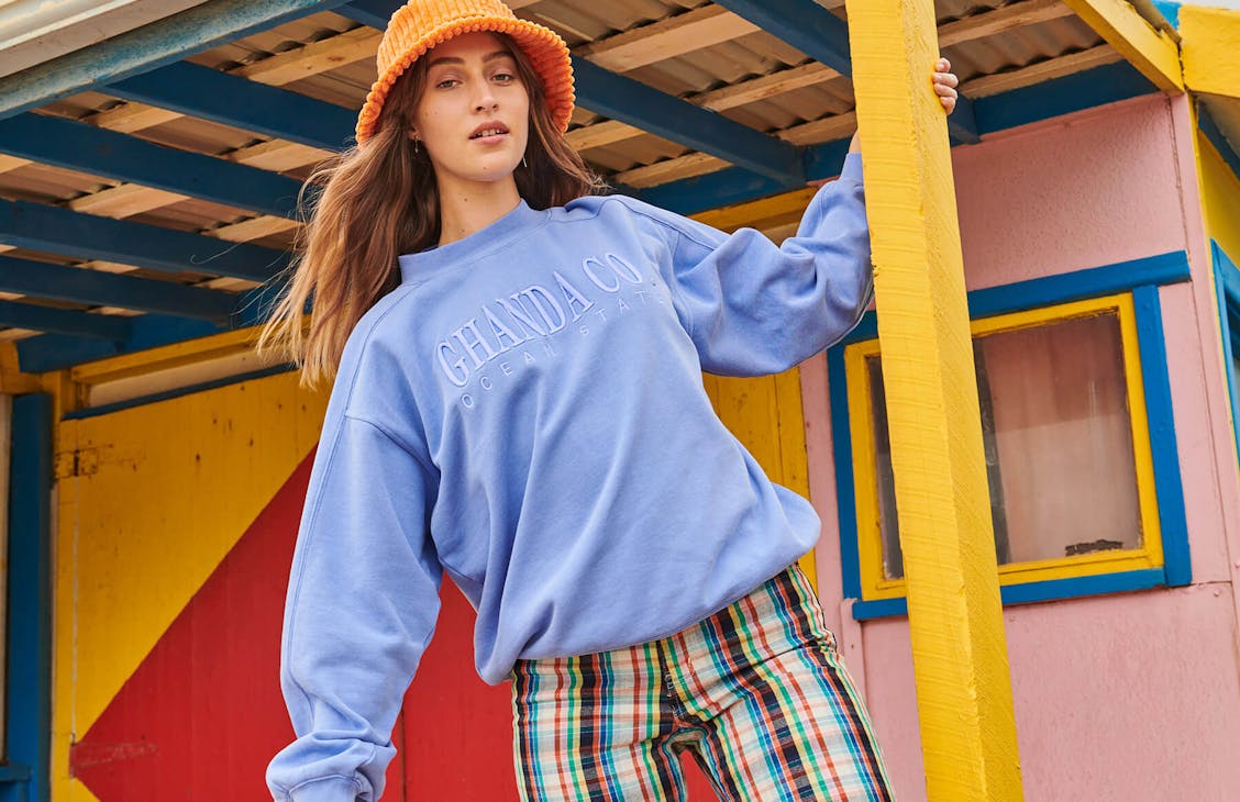 Female model wearing the Throwback Crew in washed blue 