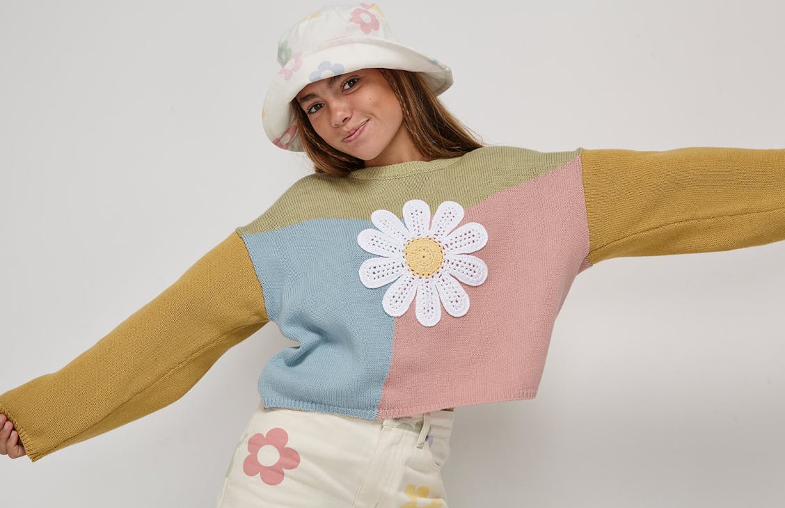 Young female model wearing the daisy panel knit in pistachio multi