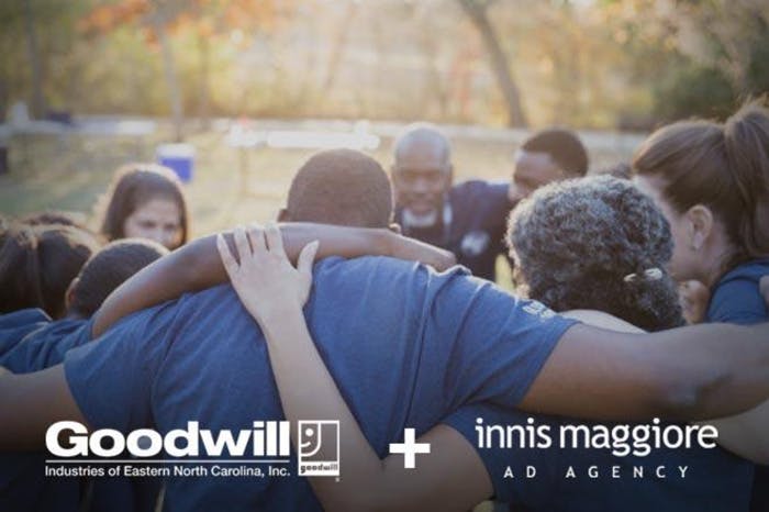 group of people standing in circle with arms around shoulders