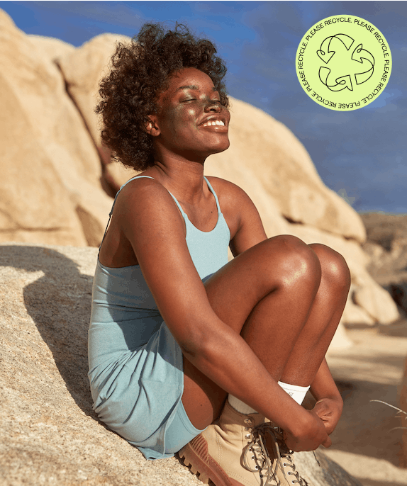 woman smiling wearing Girlfriend Collective dress promoting ReGirlfriend