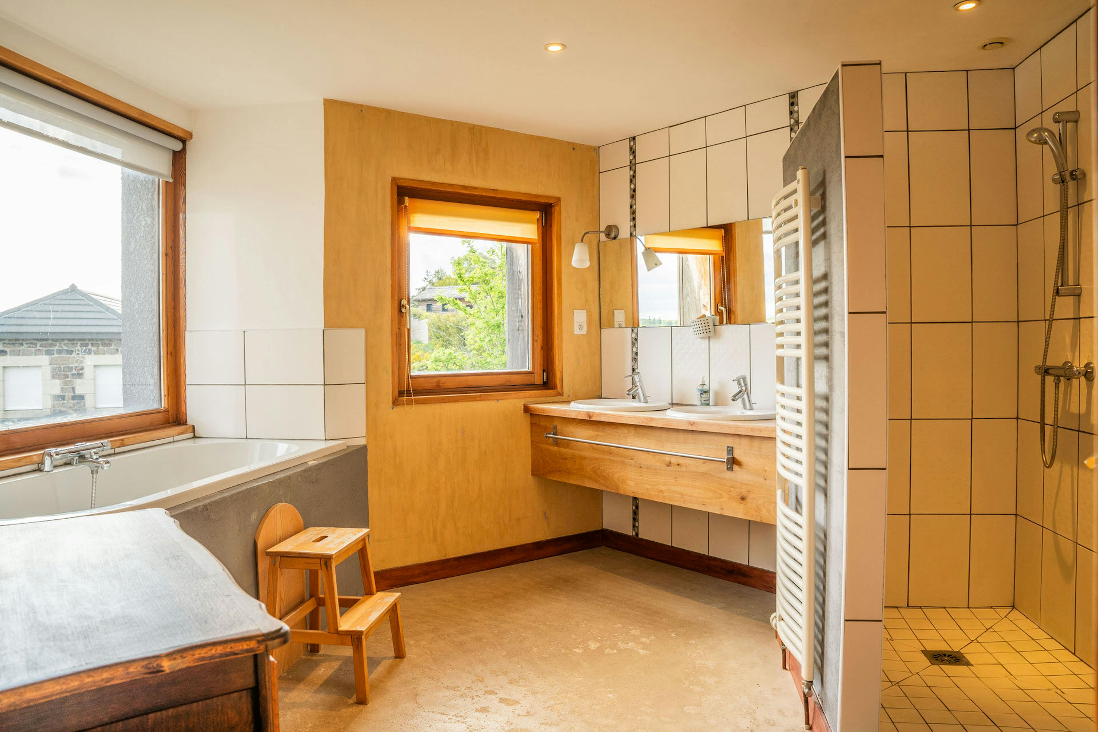 Espace salle de bain avec douche baignoire et lavabos