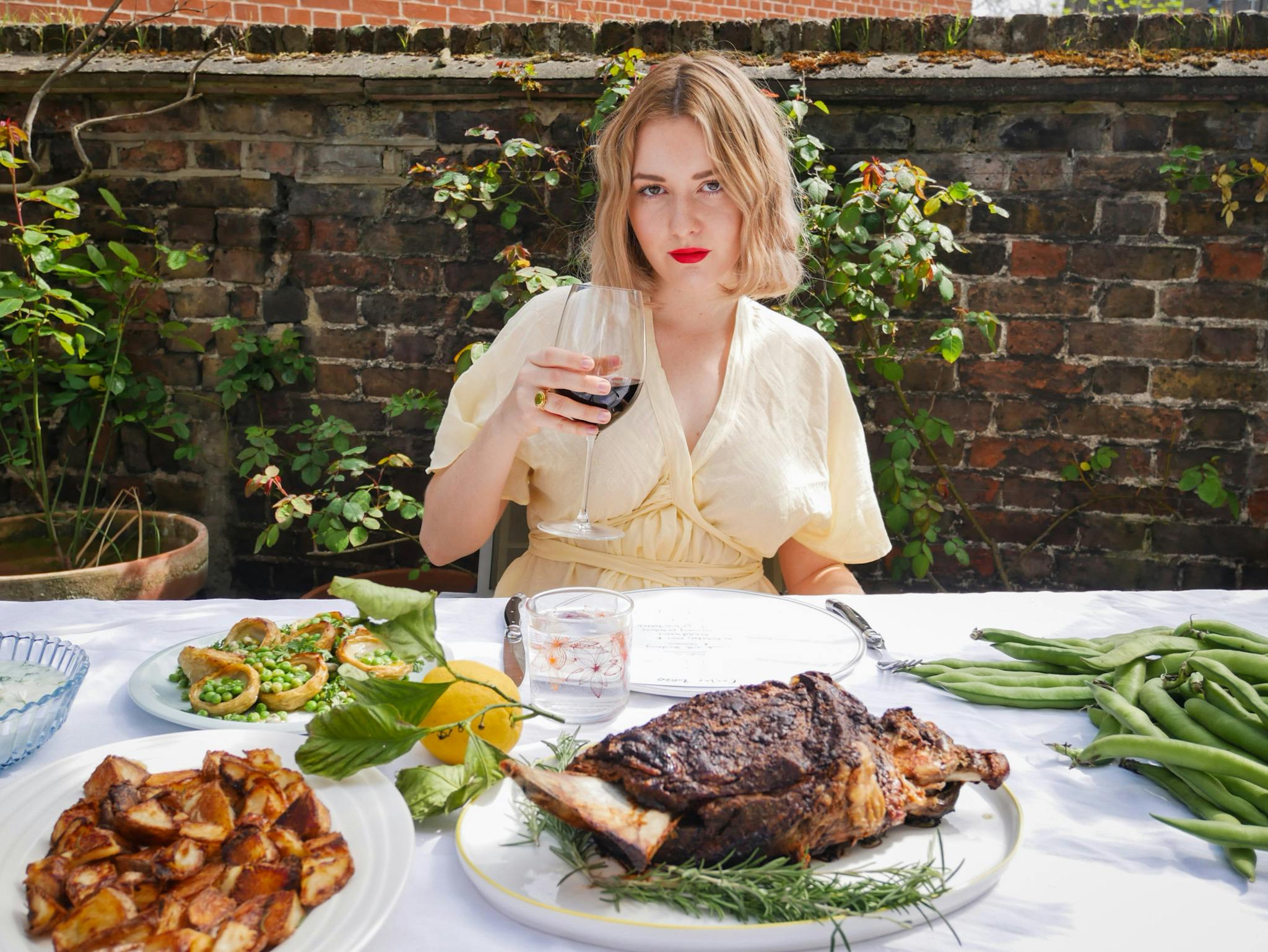 Bre Graham sat outside at a table with food spread in front of her