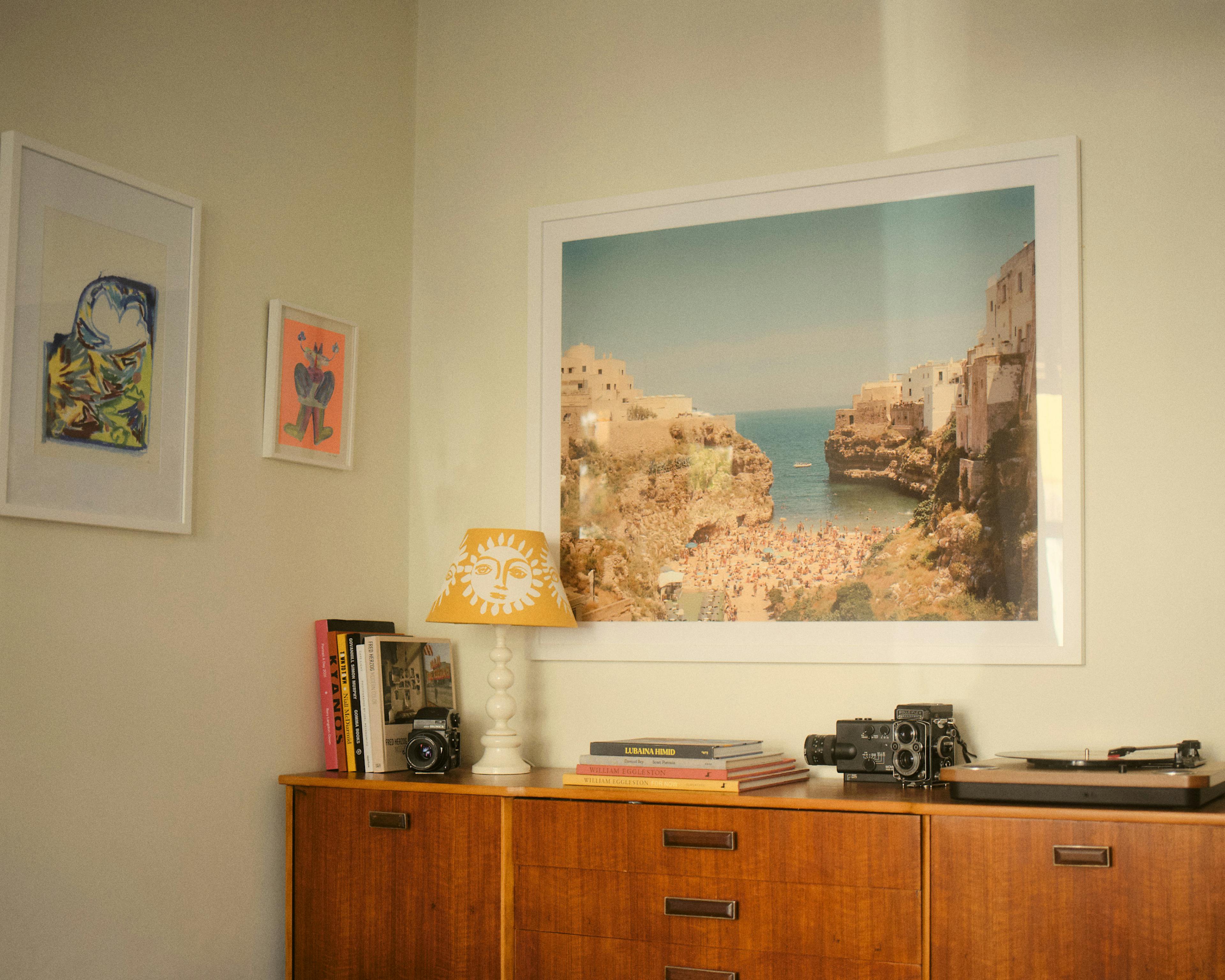 A corner of Rory Langdon Down's home with photography print and yellow sun lamp