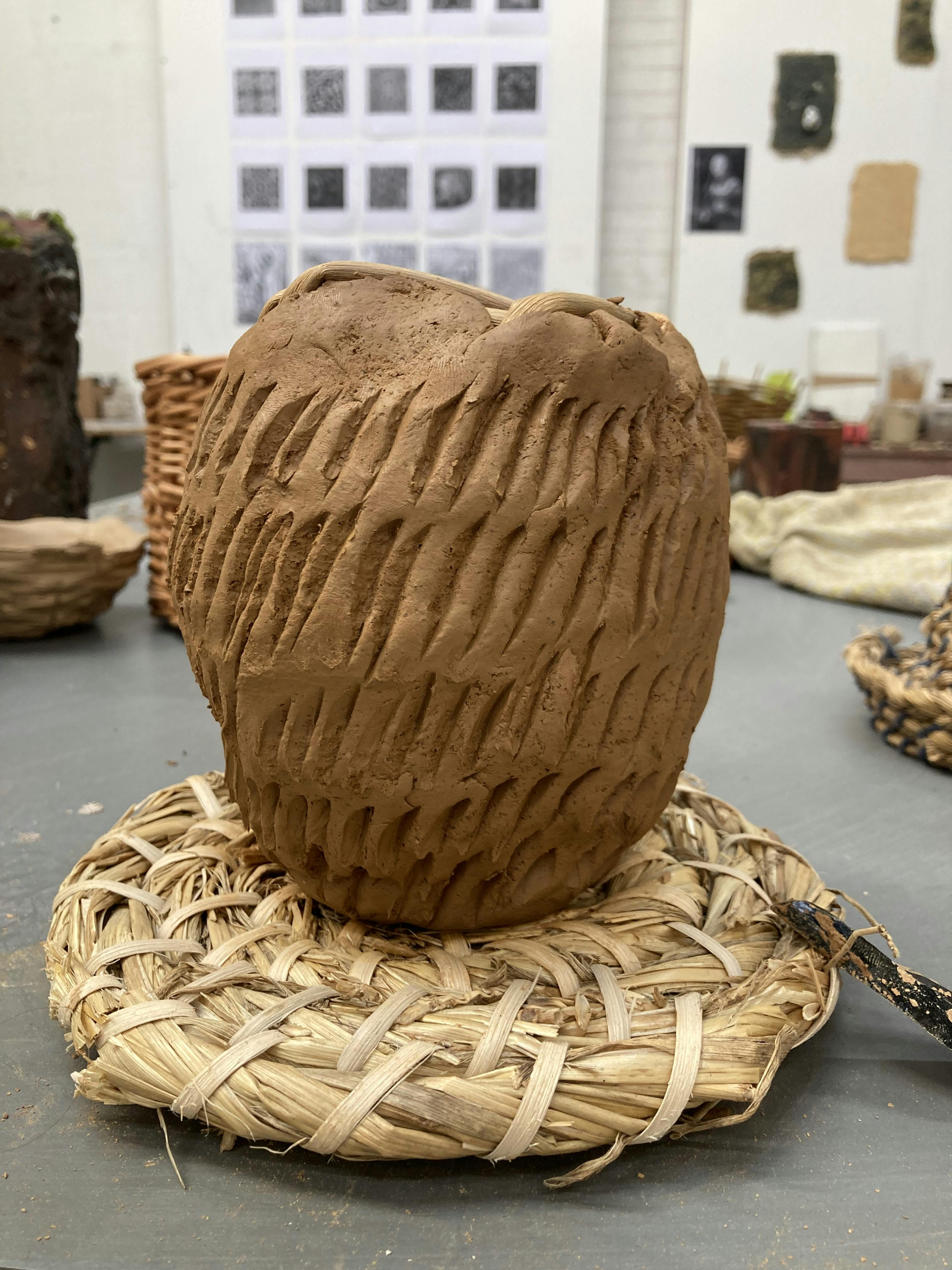 A wet clay pot with rough texture.