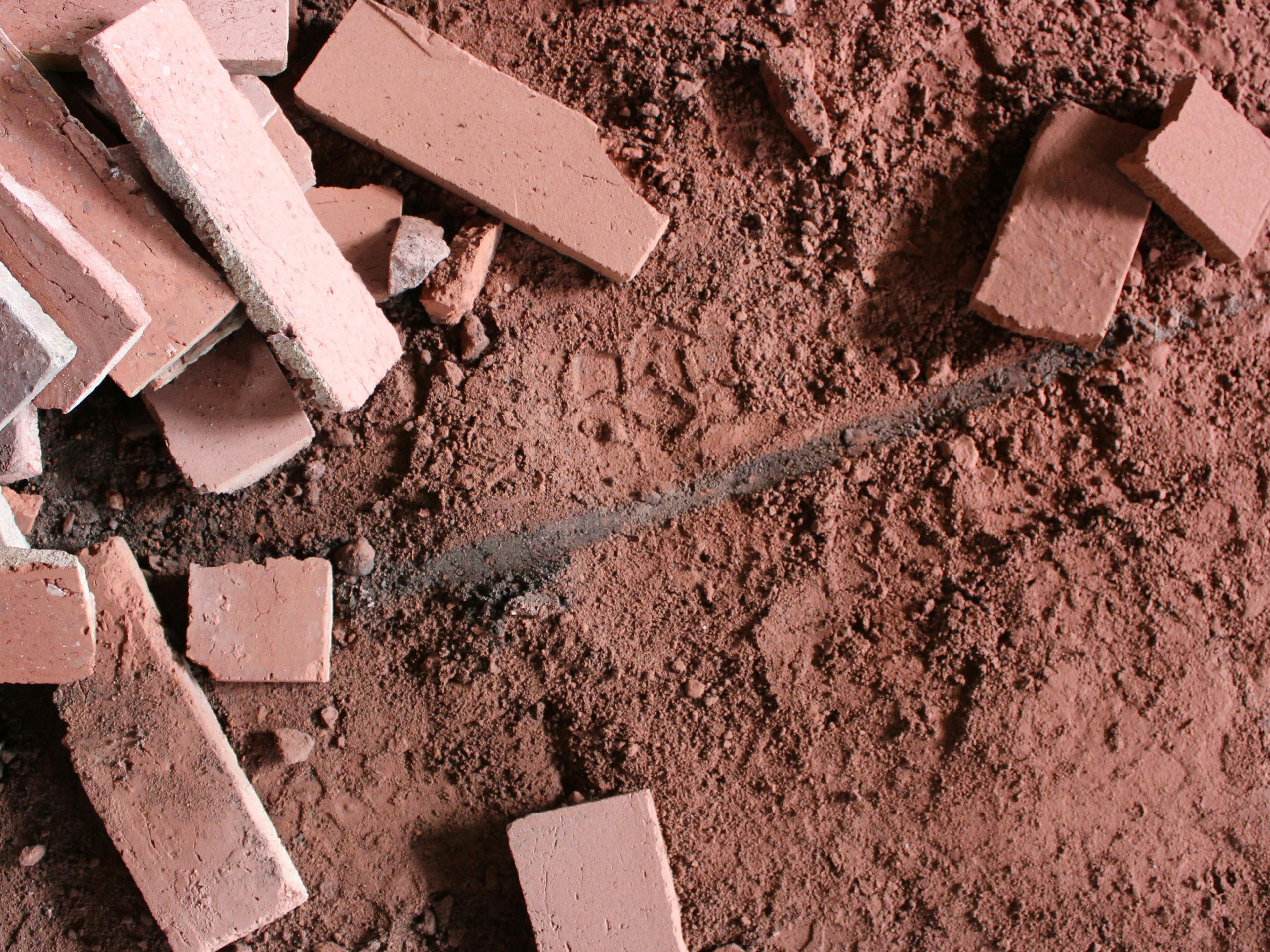 The image shows red brick chunks and red terracota brick dust. 