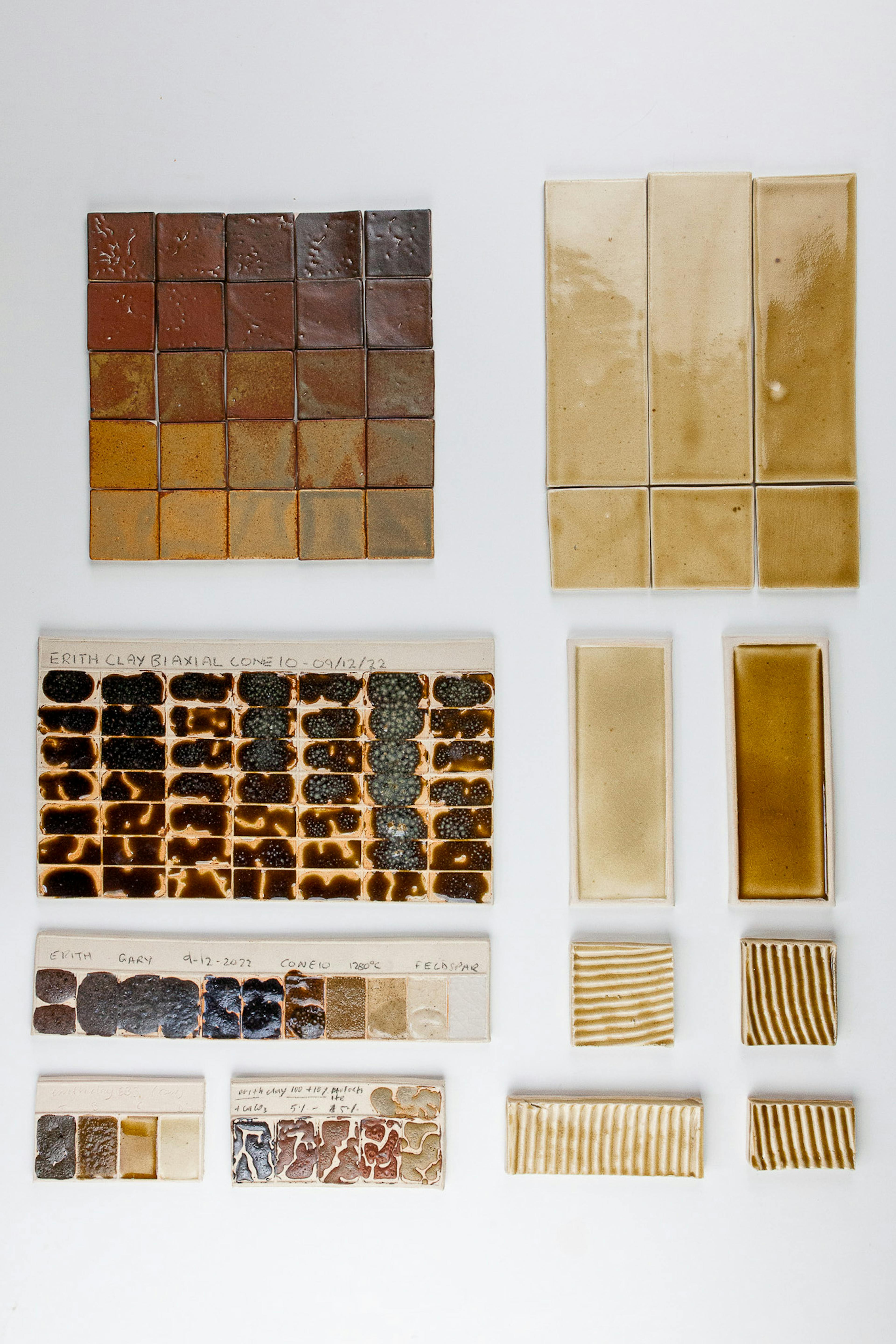 A set of ceramic test tiles. They are of warm brown, honey and ochre tones. These tiles wee made using waste materials collected in Erith Londond 