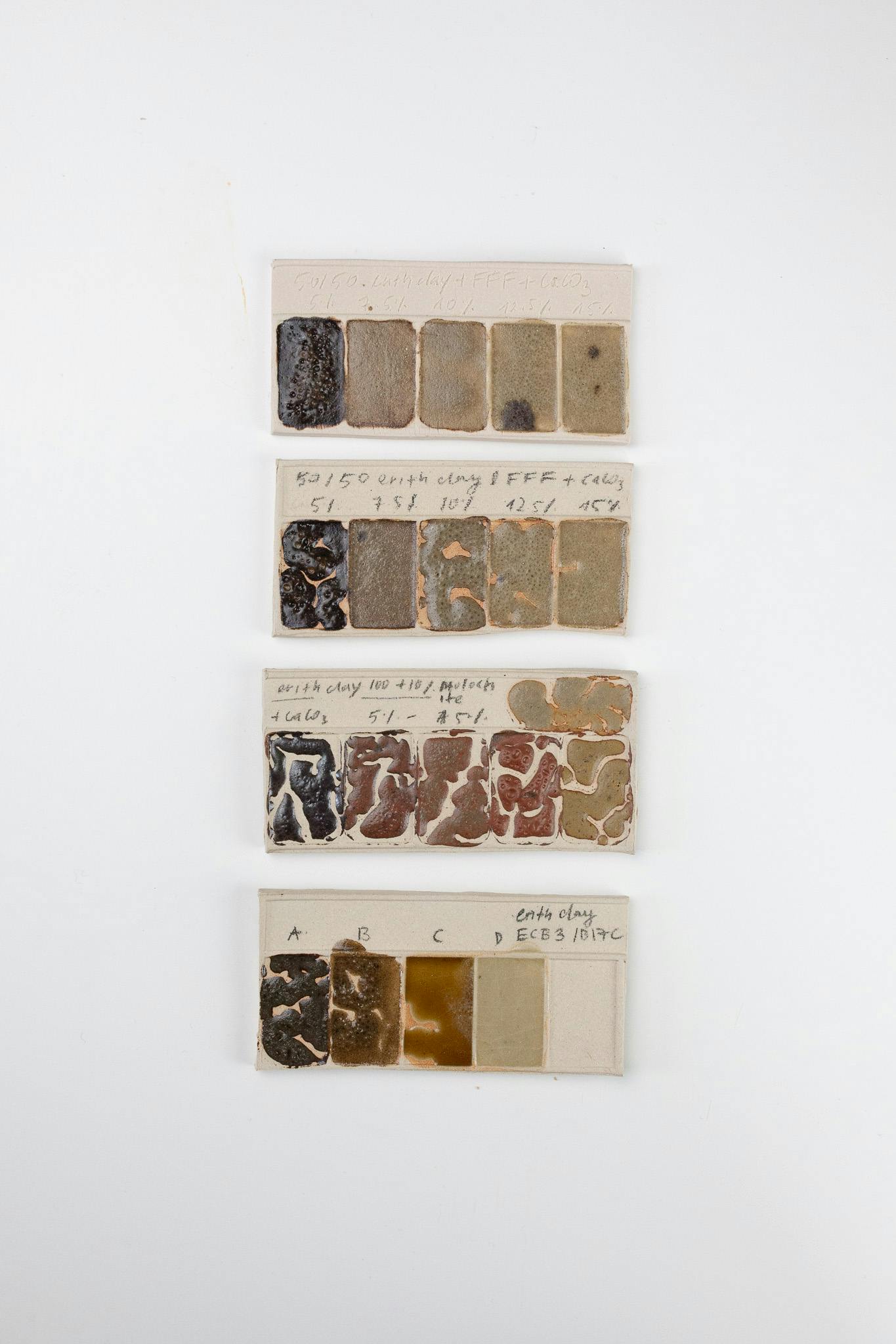 A set of ceramic test tiles. They are of warm brown, honey and ochre tones. These tiles wee made using waste materials collected in Erith Londond