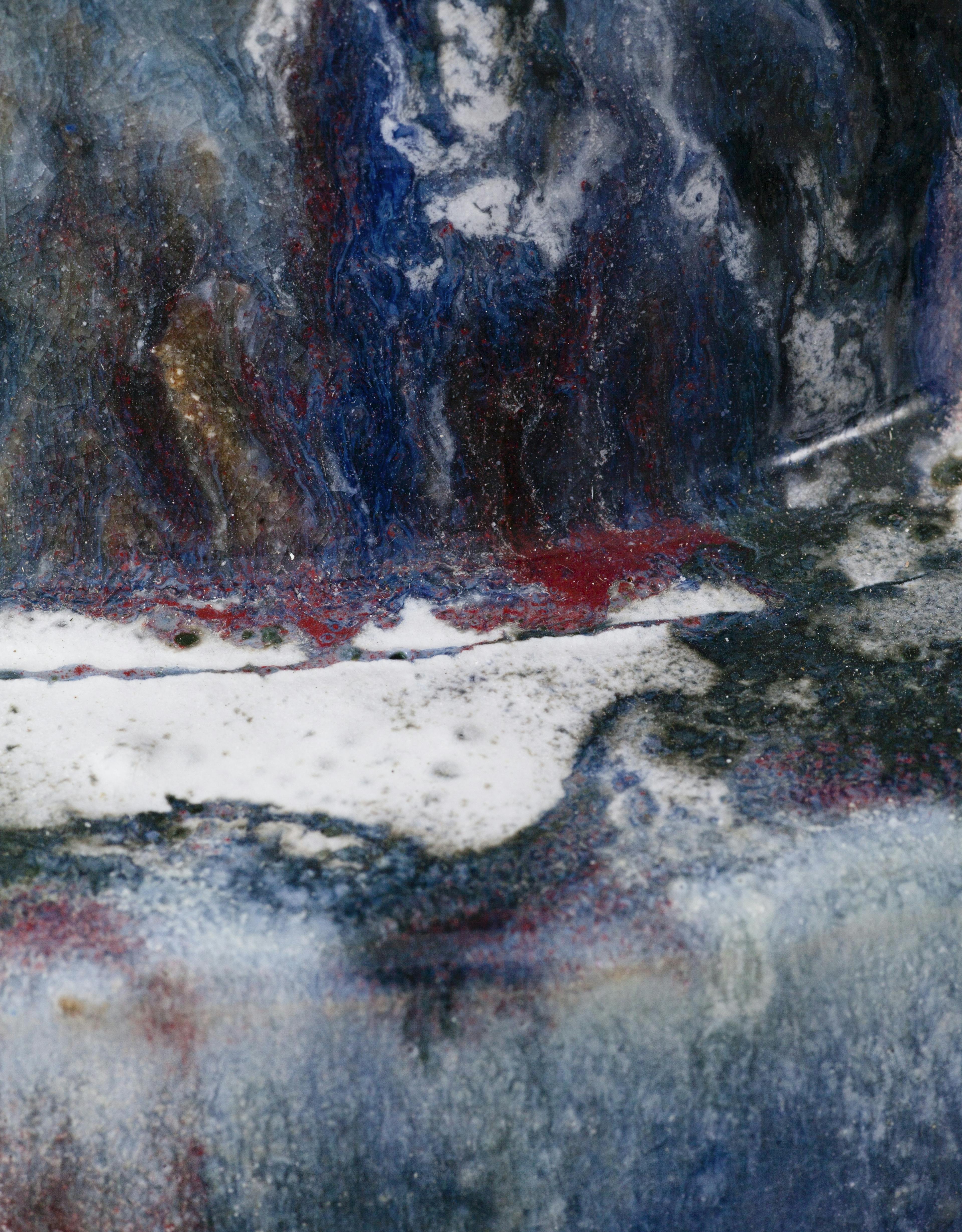 An image showing a zoom in of a glazes ceamic sculpture by Elena Gileva. It is dark blue, with white floating streaks and flashes of red. 