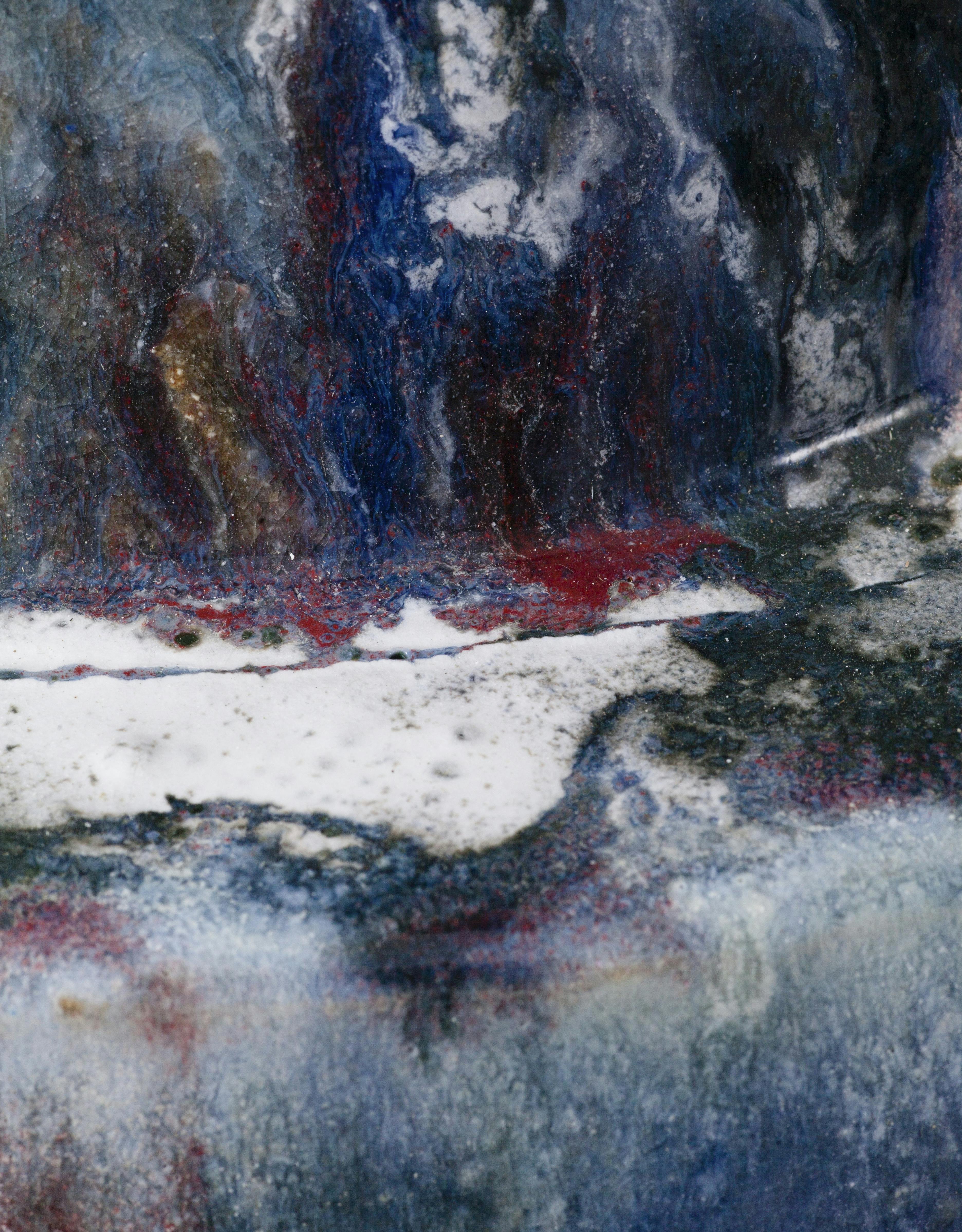 An image showing a zoom in of a glazes ceamic sculpture by Elena Gileva. It is dark blue, with white floating streaks and flashes of red.