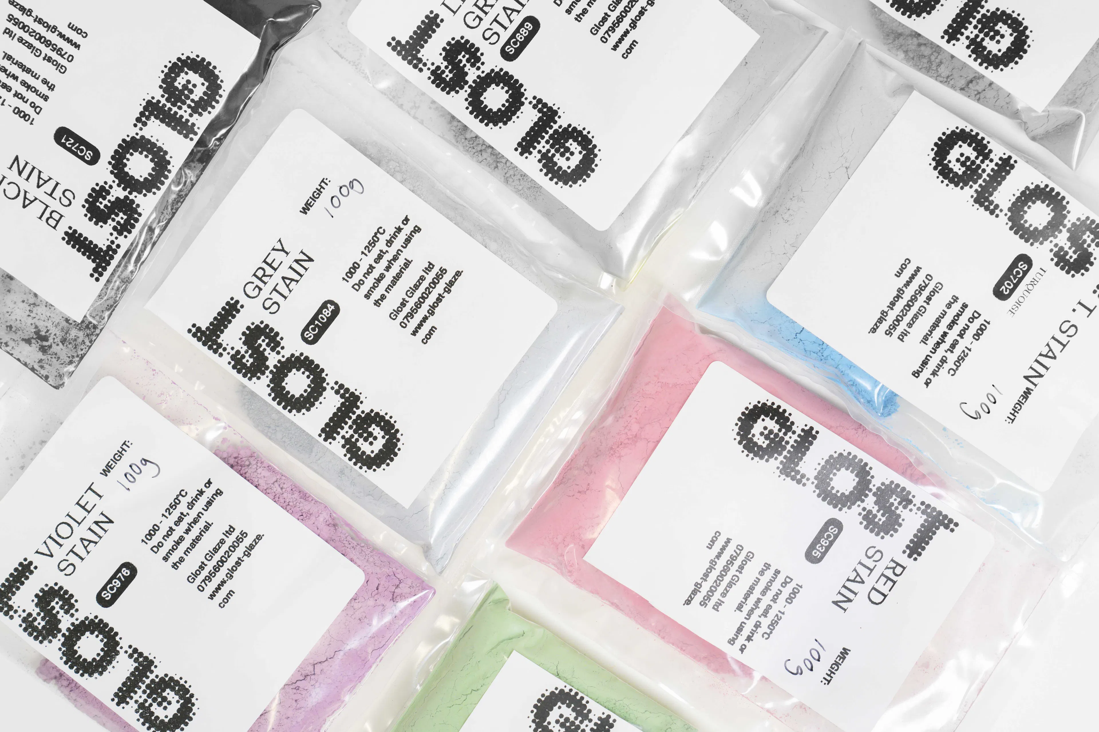 sachets of ceramic inclusion stains with GLOST logo