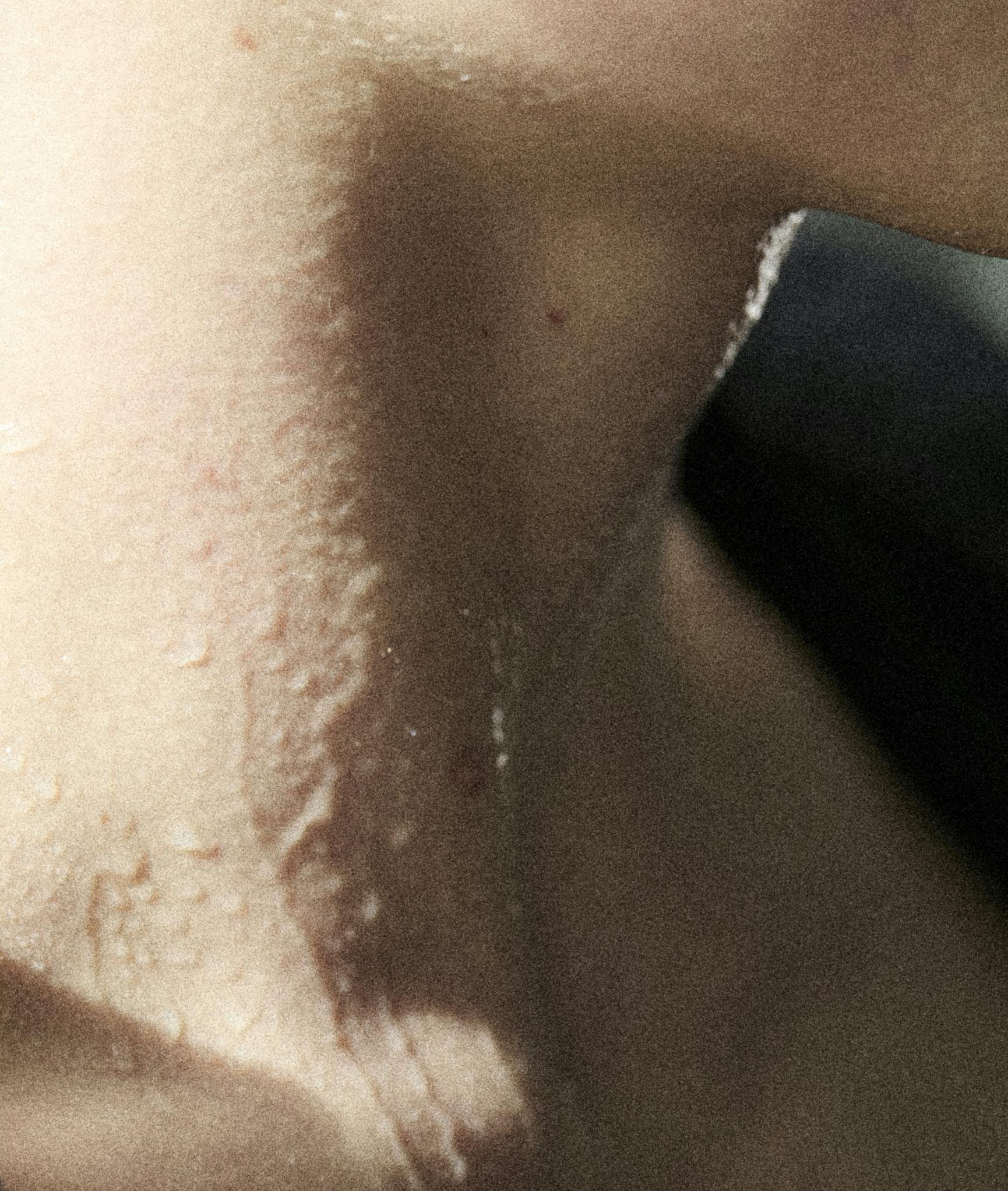 A model's neck wet with sweat