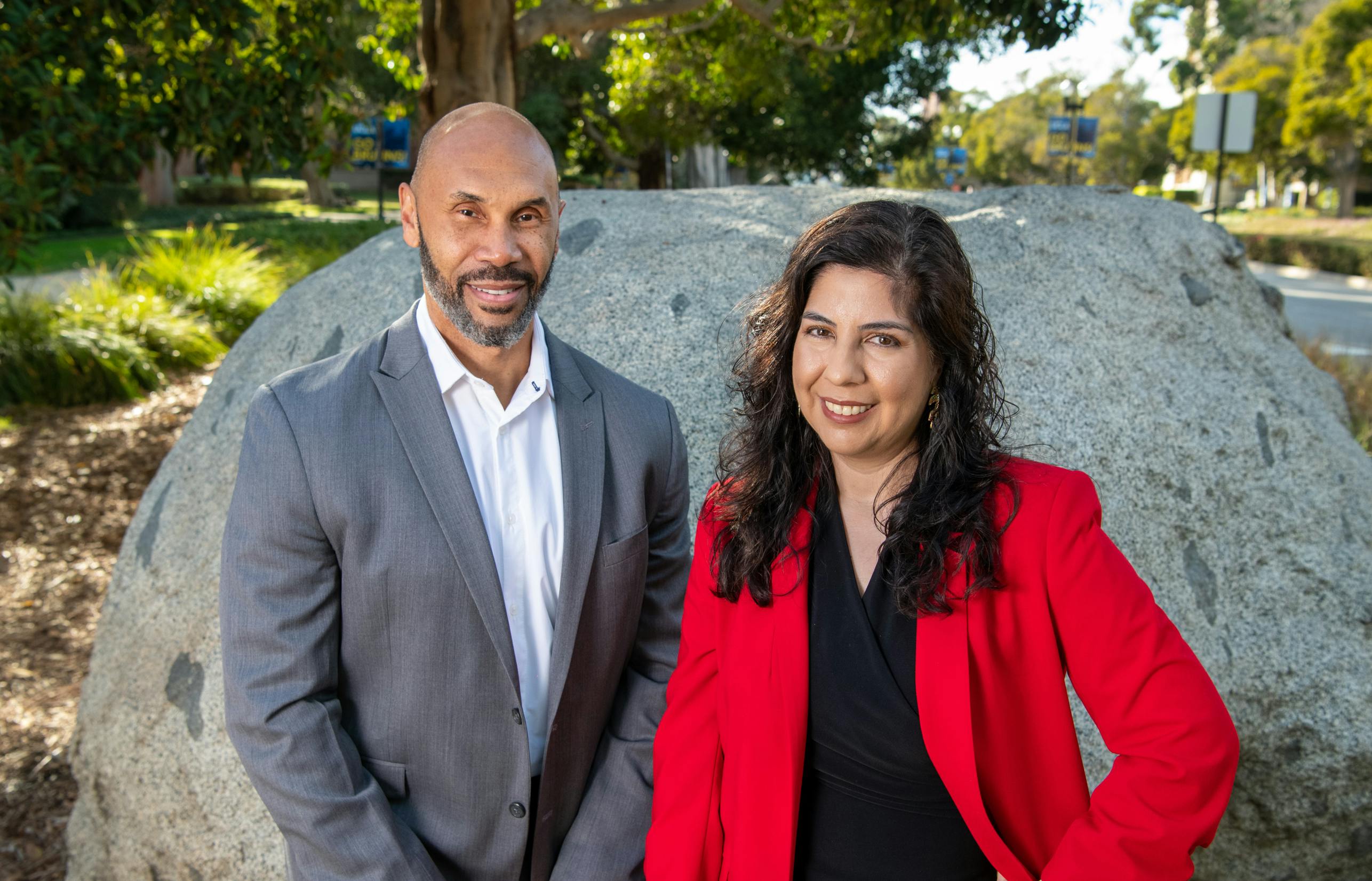 Darnell Hunt, dean of UCLA social sciences and Ana-Christina Ramon, director of research and civic engagement in the social sciences pose together in front of Founder's Rock on the UCLA campus.
