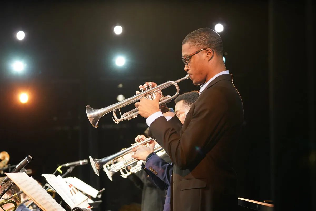 A trumpet player performs a solo with an orchestra