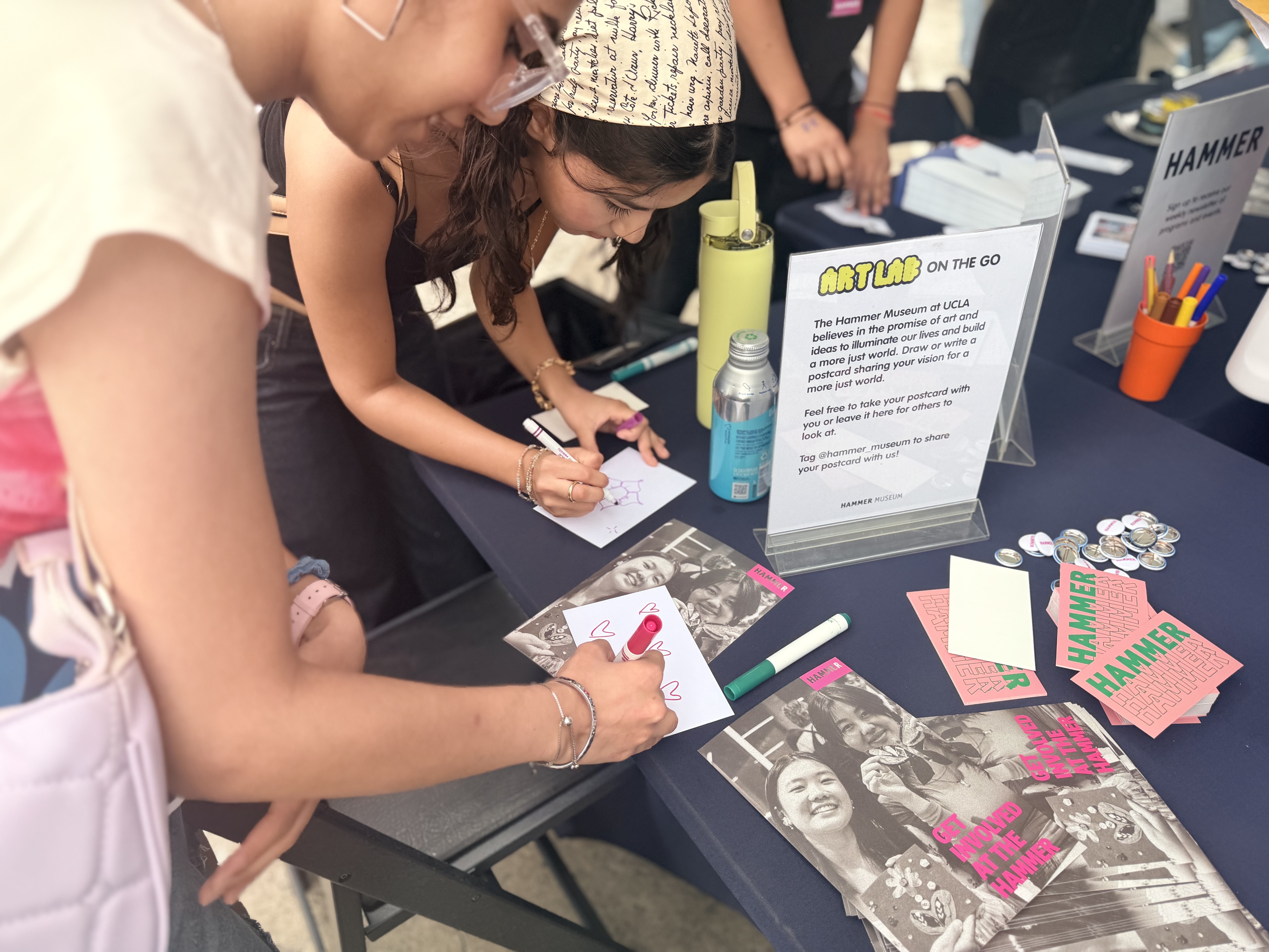 Students make postcards with colorful markers