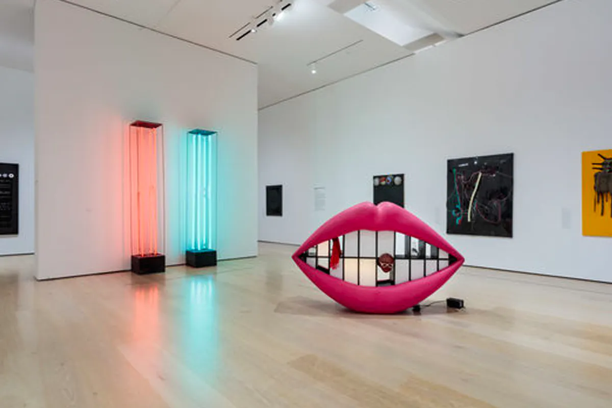 Exhibition overview photo of giant lips sculpture and light installations