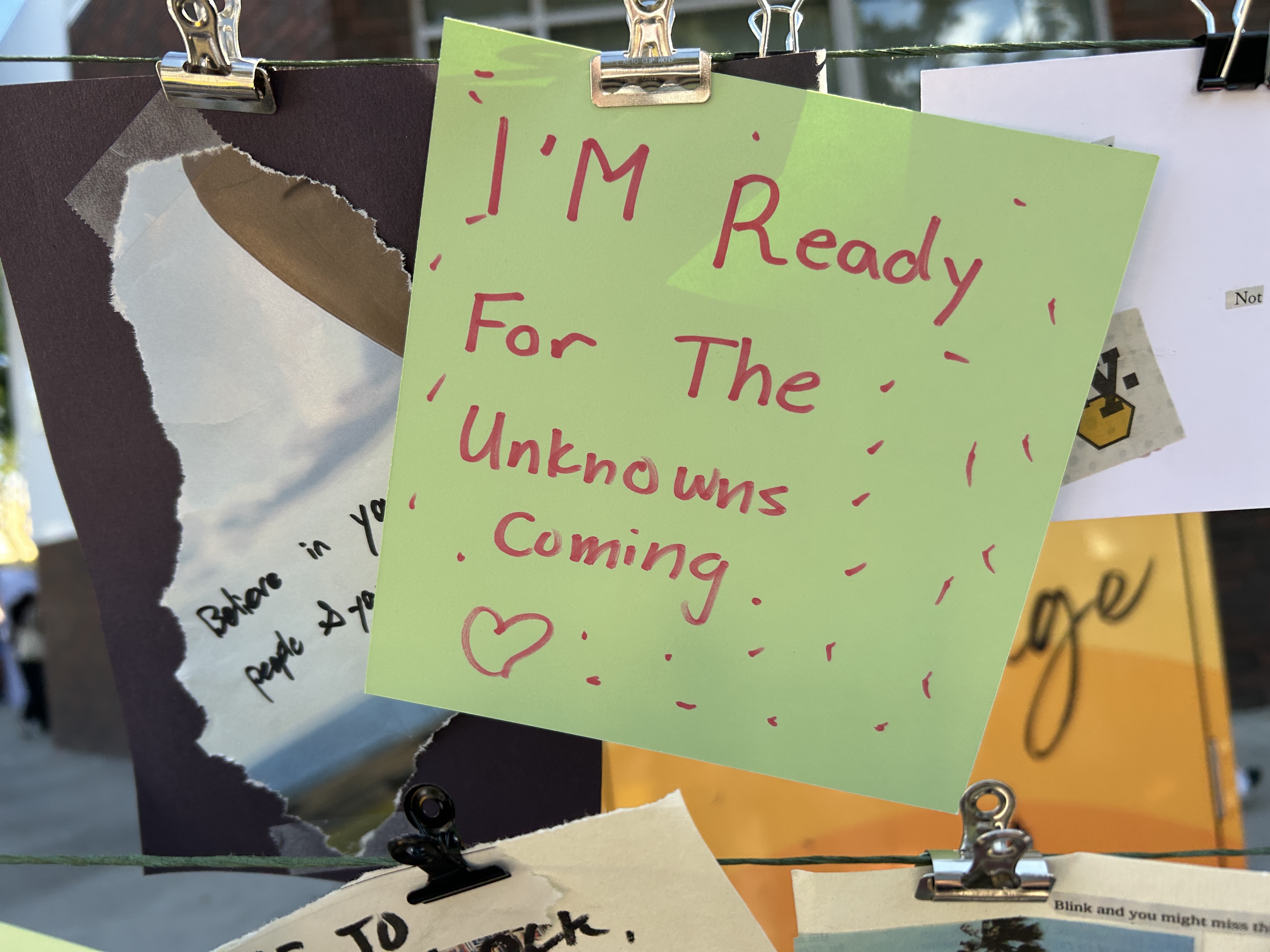 A green piece of paper with the phrase "I am ready for the unknowns coming"