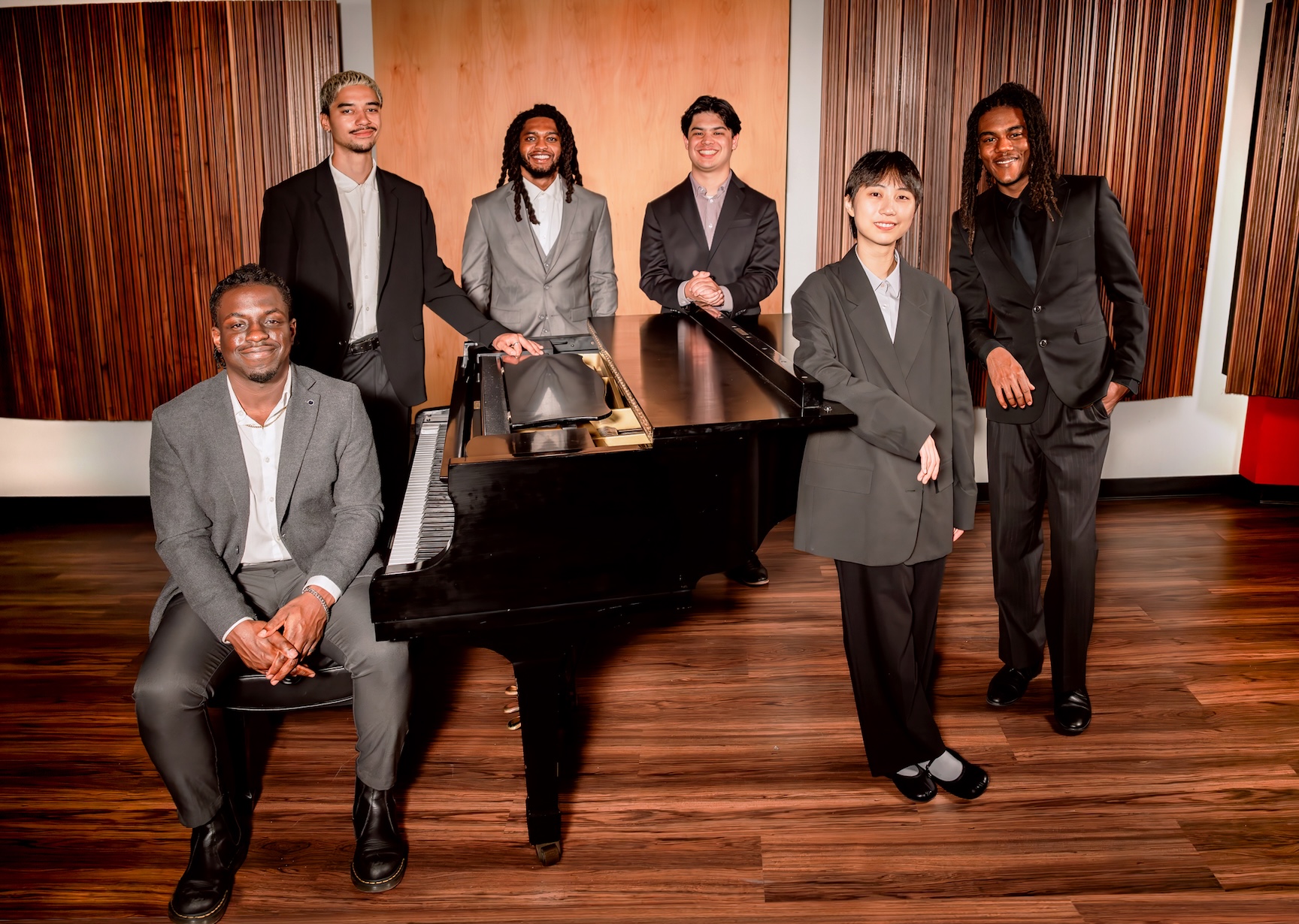 student ensemble gathered around a piano