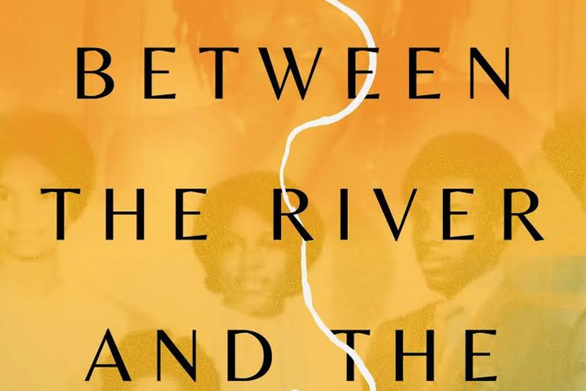 Closeup of a film poster. Yellowish orange background with the text "Between the River and the Railroad Tracks"