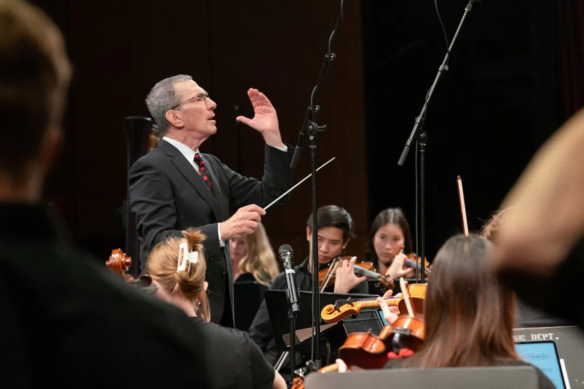 A conductor in front of an orchestra
