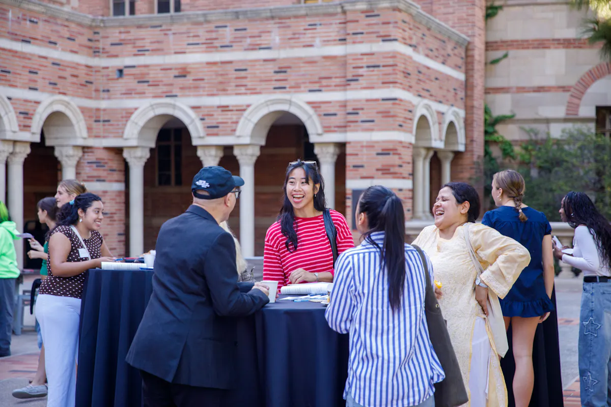 Dean lionel popkin chats with UCLA Arts students on the royce terrace