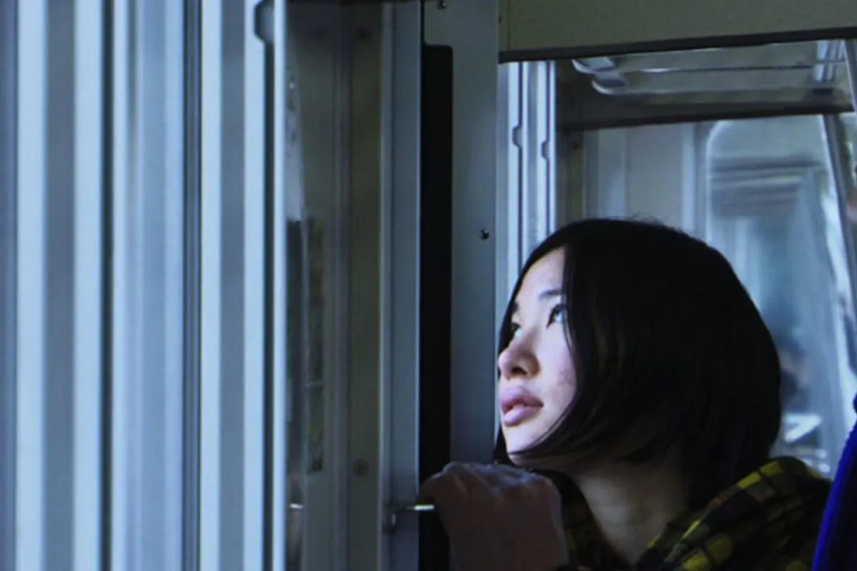 a woman looking out the window on a train