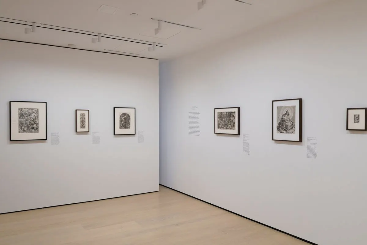Gallery with framed works on paper mounted on the wall