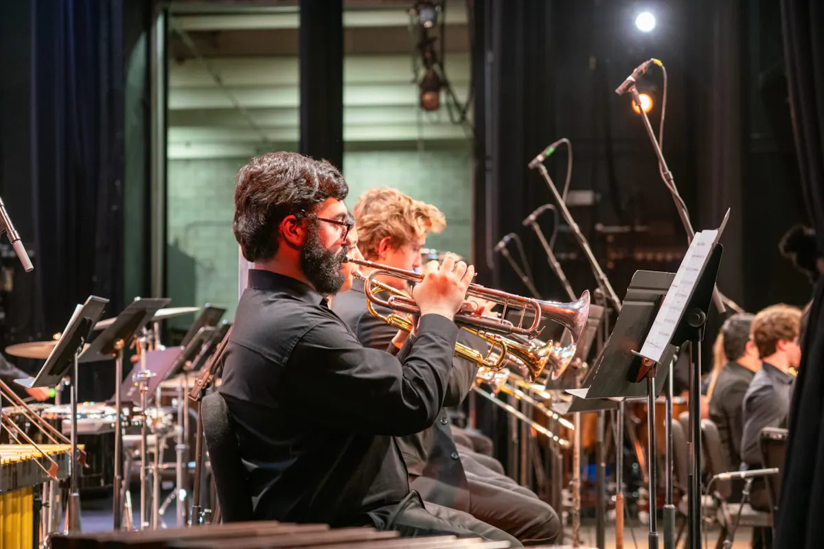 Trumpet players performing with a large ensemble