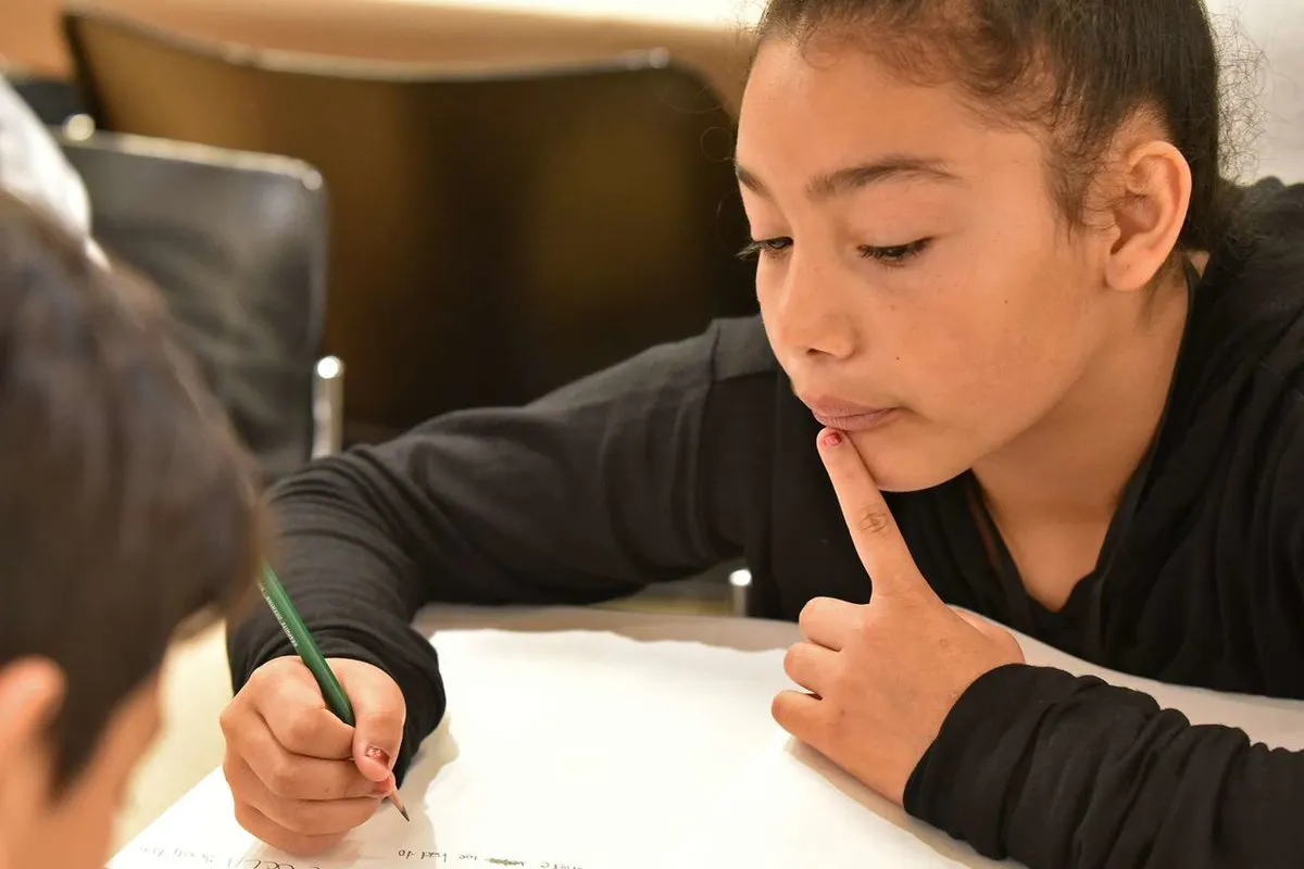 Child writing in a notebook.