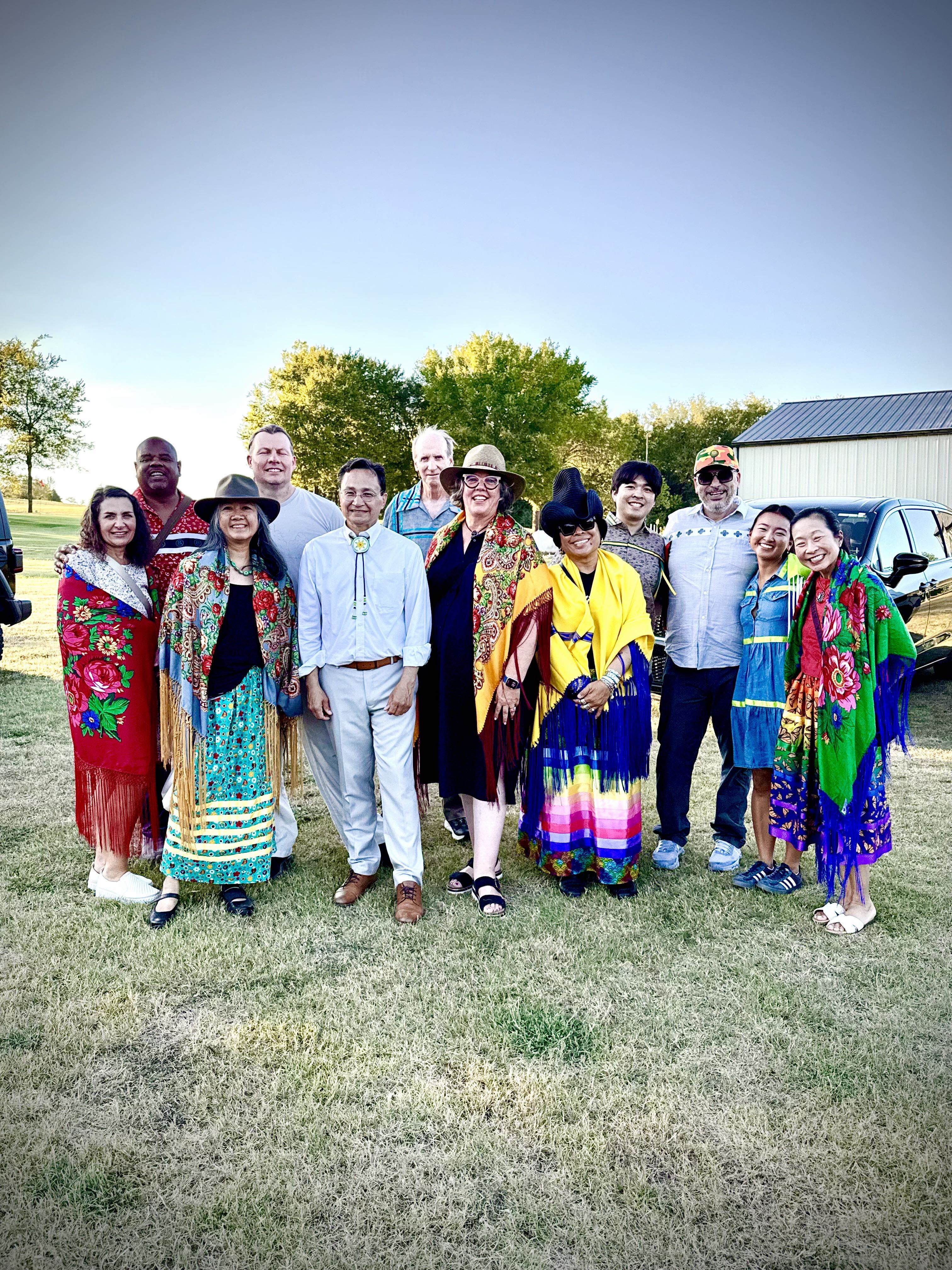 A group of people pose in vibrant clothing