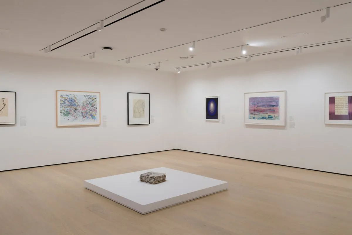 Gallery with works on paper installed on the wall and on a plinth