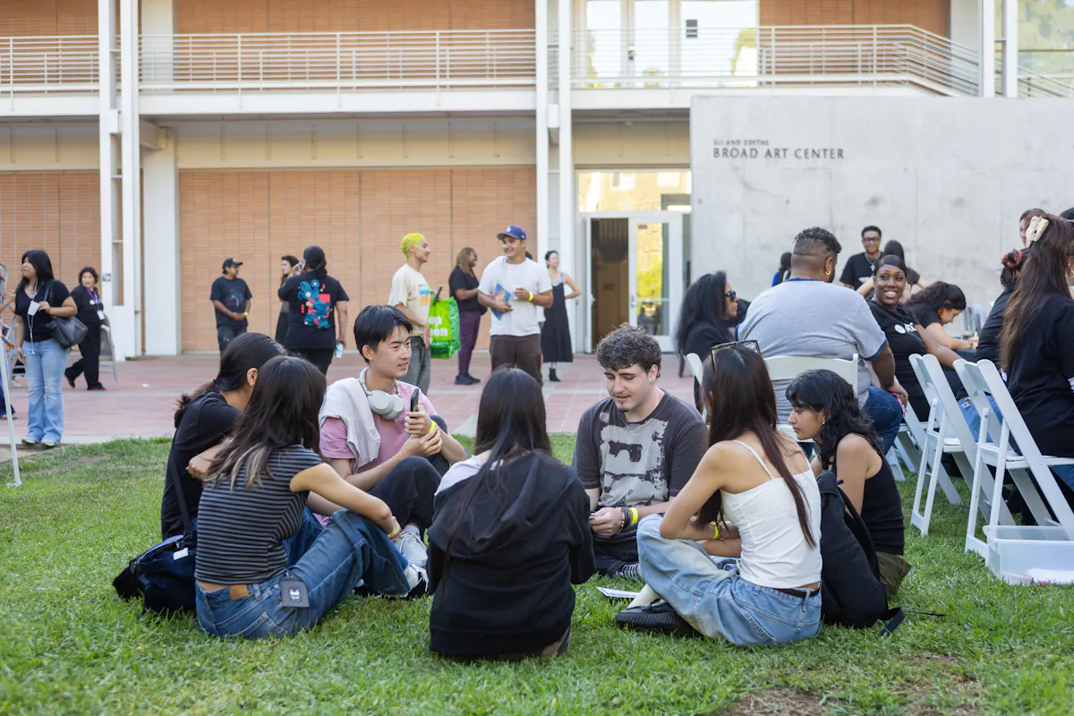 Students sit in a circle together on the Broad Lawn at UCLA
