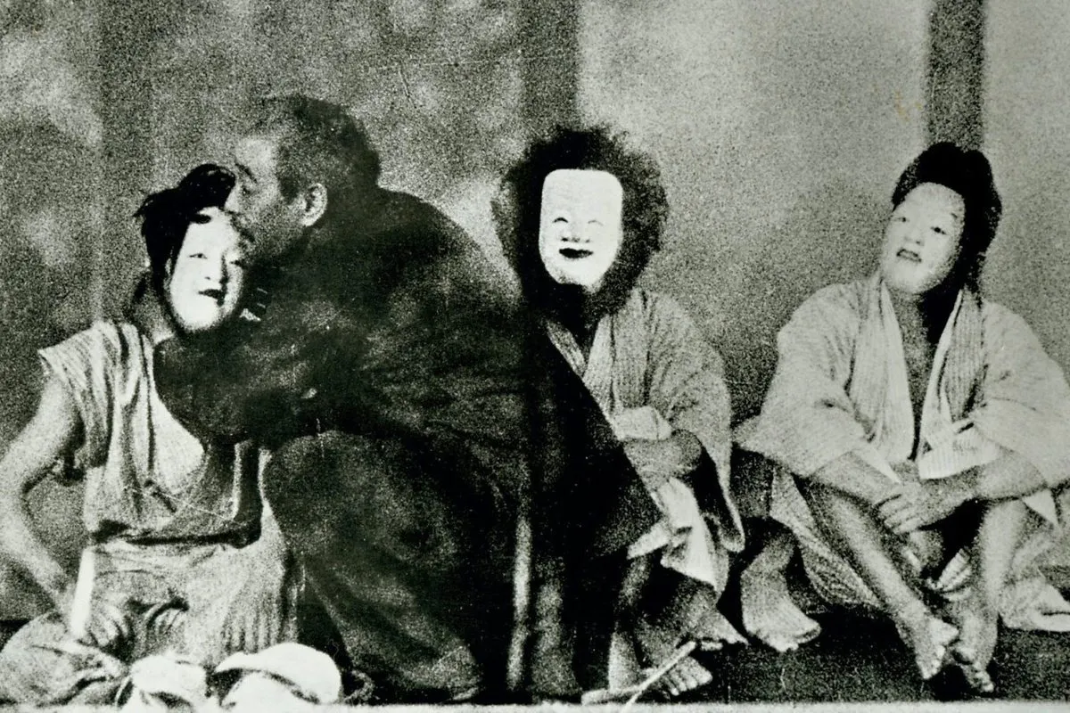3 people with masks sitting on the floor. a man is embracing one of them