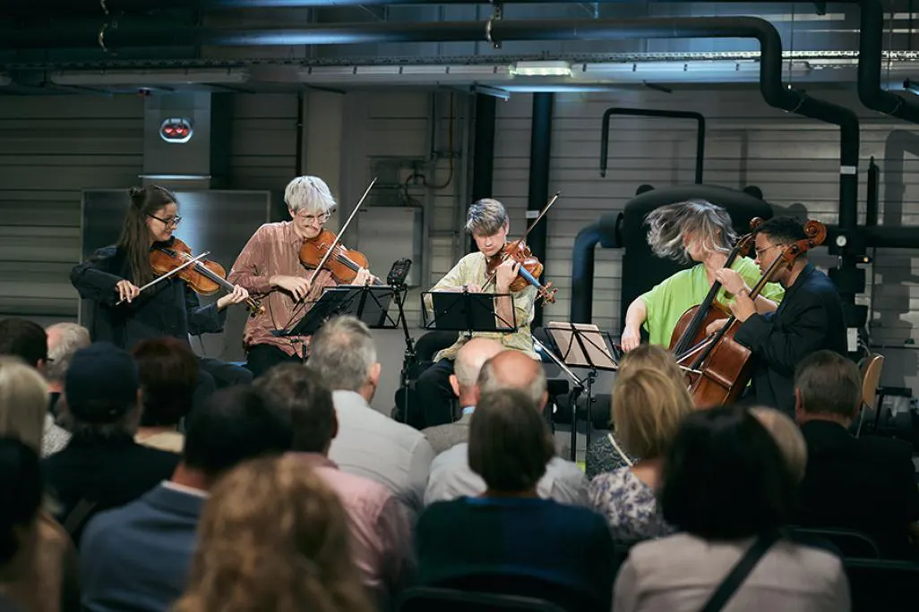 group members of inti figgis-vizueta performing their instruments in front of a live audience