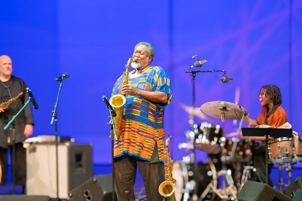 a jazz ensemble performs onstage with a saxophonist front and center