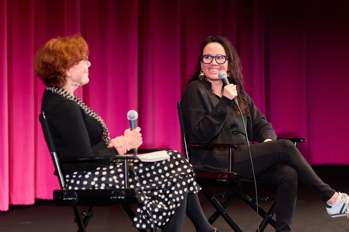 Two women on a stage with microphones. Q&A with UCLA School of Theater, Film and Television professor Kathleen McHugh and filmmaker Danis Goulet