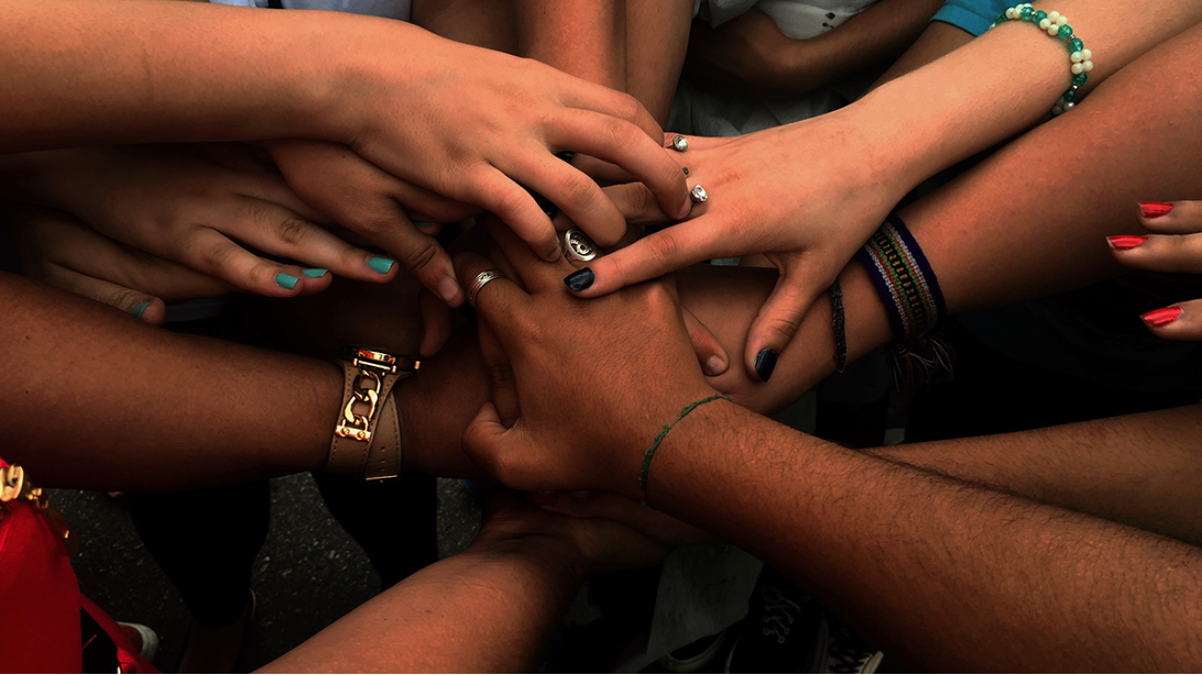 Hands joining and placing over one another.