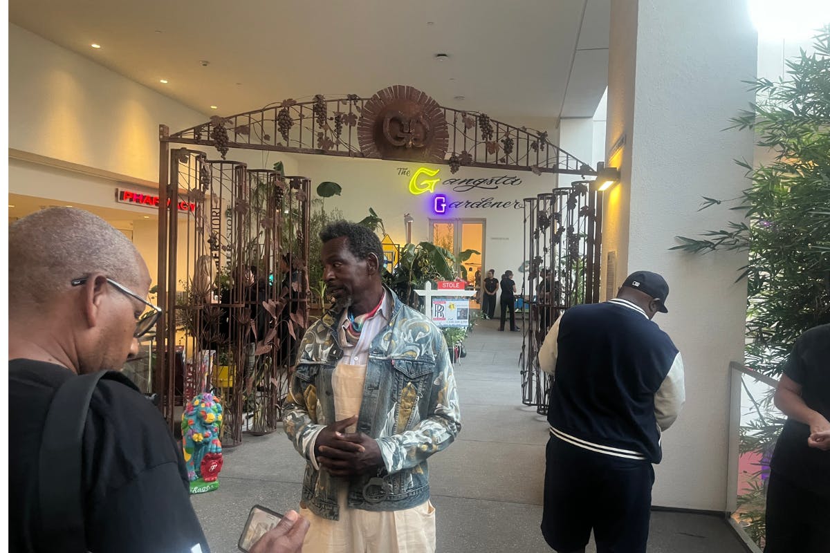 artist Ron Finley talks to visitors outside his garden at the Hammer Museum