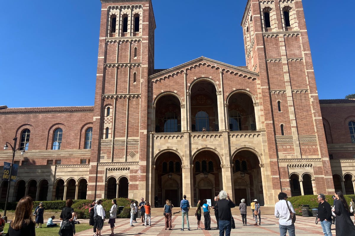 people stand outside of Royce Hall listening to a Bill Fontana sound exhibition called Silent Echoes